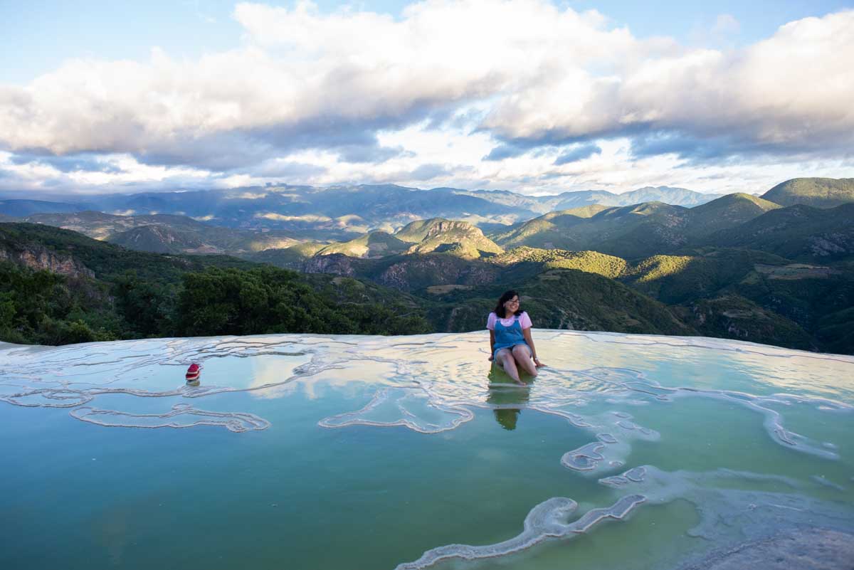 A lady poses for a photo at the edge of Hierve El Agua, Oaxaca, Mexico