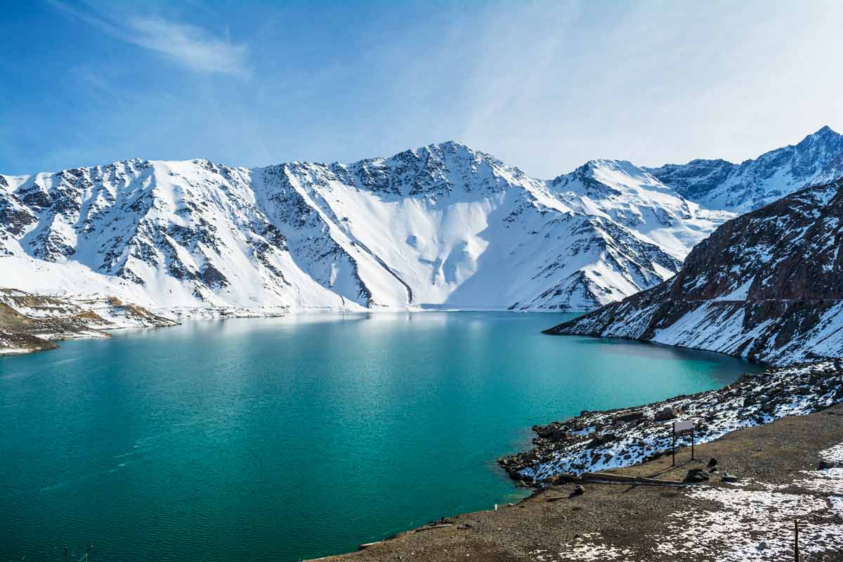 snow capped mountains and blue lake at Cajon del Maipo in SanTiago, Chile