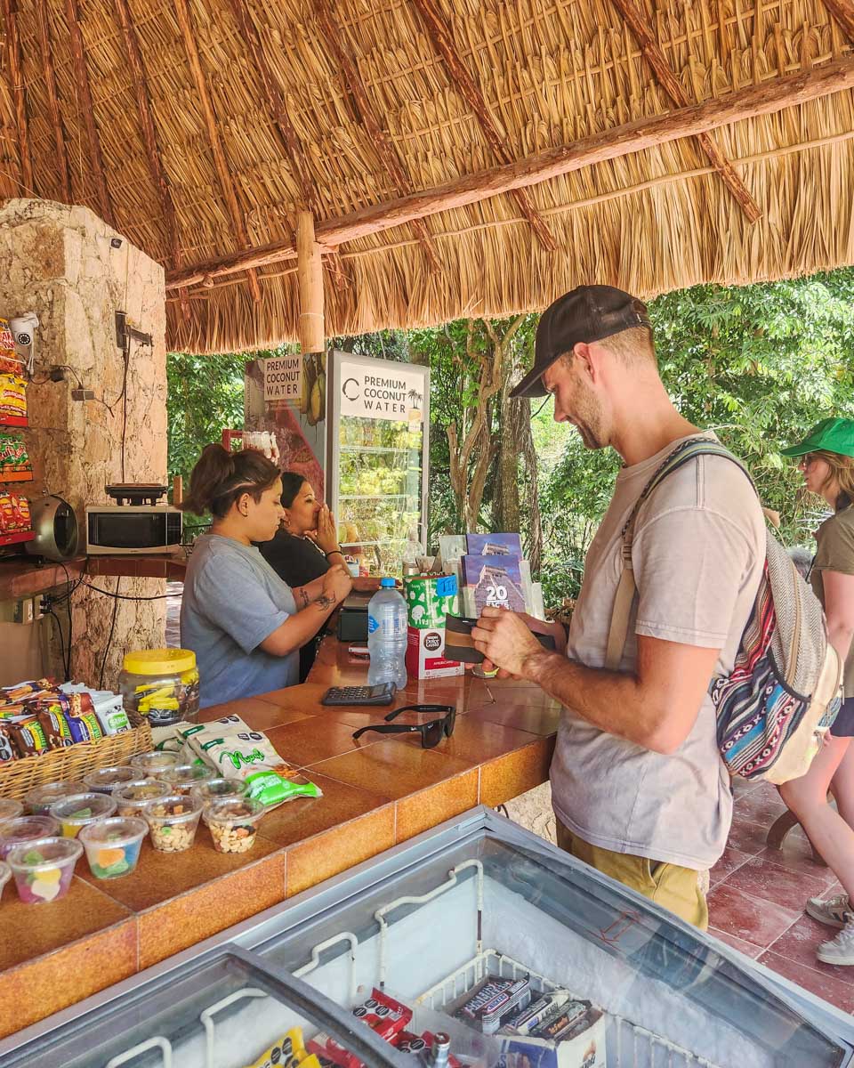Daniel buys water at a shop at Chichen Itza