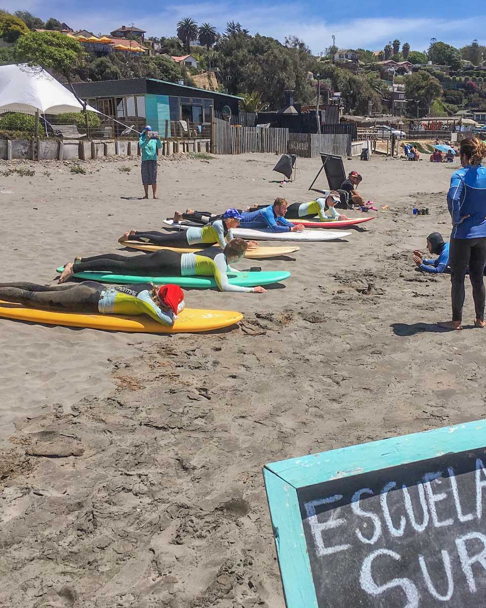 A group of people learn to surf in Valparaiso, Chile