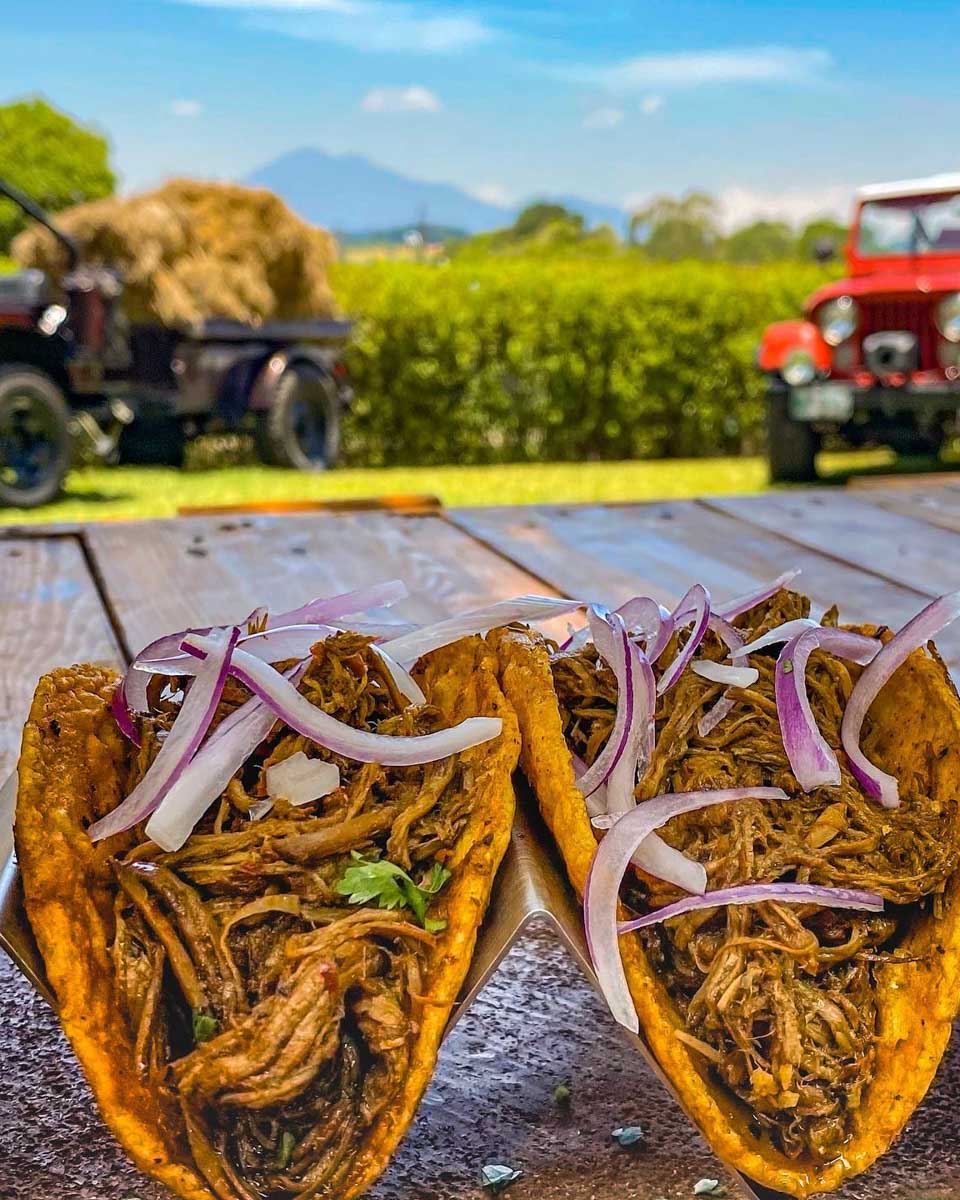 Two hard shell tacos at La Tasca Antigua with a beautiful view in Antigua, Guatemala