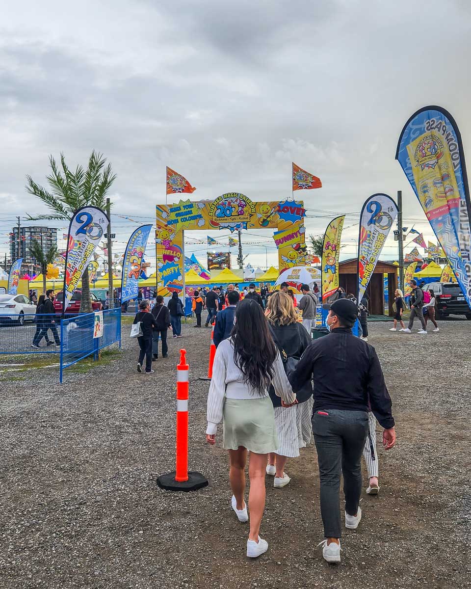 People walk into the Zoom Pass entry at the Richmond Night Market