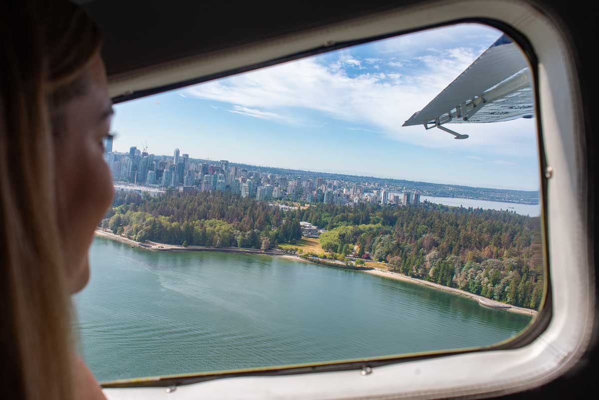 Bailey looks out the window on a sea plane as it fly's over Vancouver, Canada