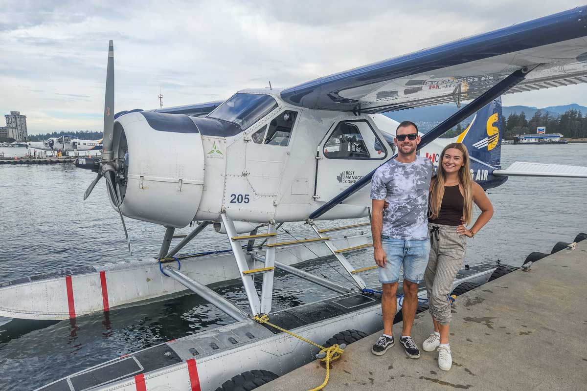 Daniel and Bailey take a photo with a sea plane in Vancouver, Canada