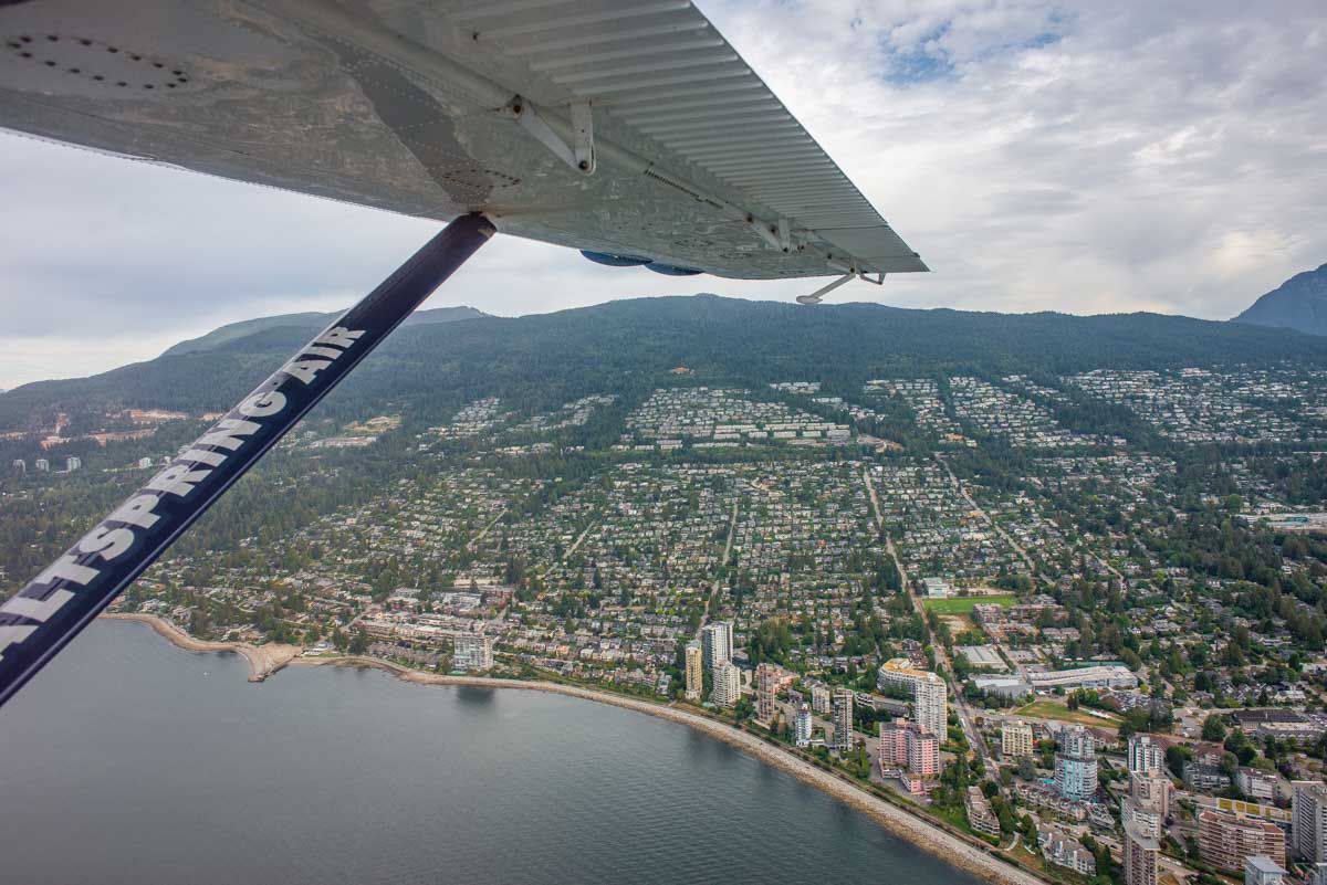 view from a float plane looking over west vancouver on a cloudy day