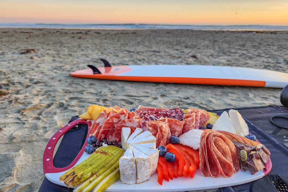 A charcuterie board at sunset at Wickaninnish Beach