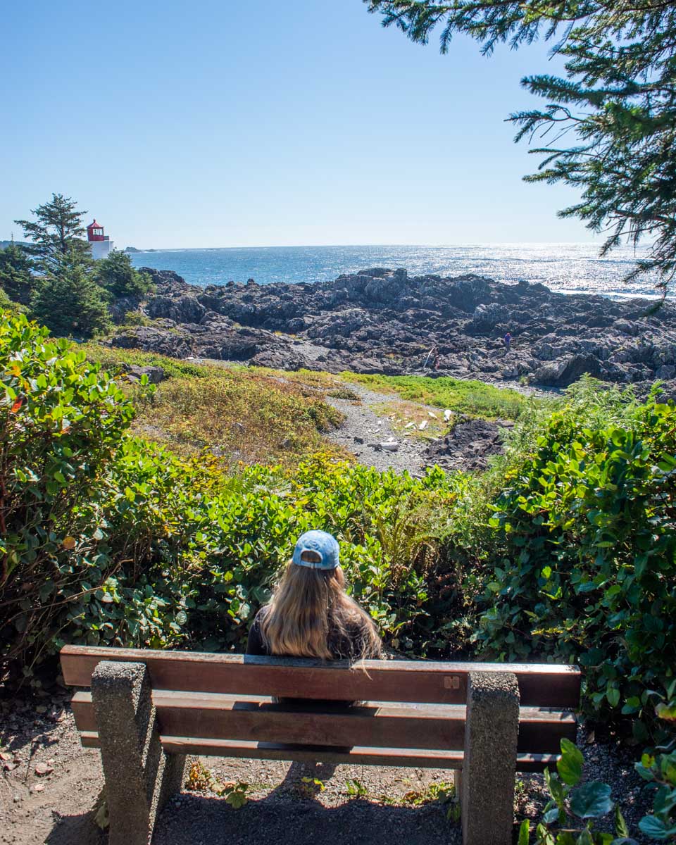 Bailey relaxes on a bench with coastlal views along the Wild Pacific Trail