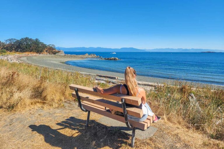 Bailey sits on a bench at Pipers Lagoon Park lookoing out at the ocean in Nanaimo, BC