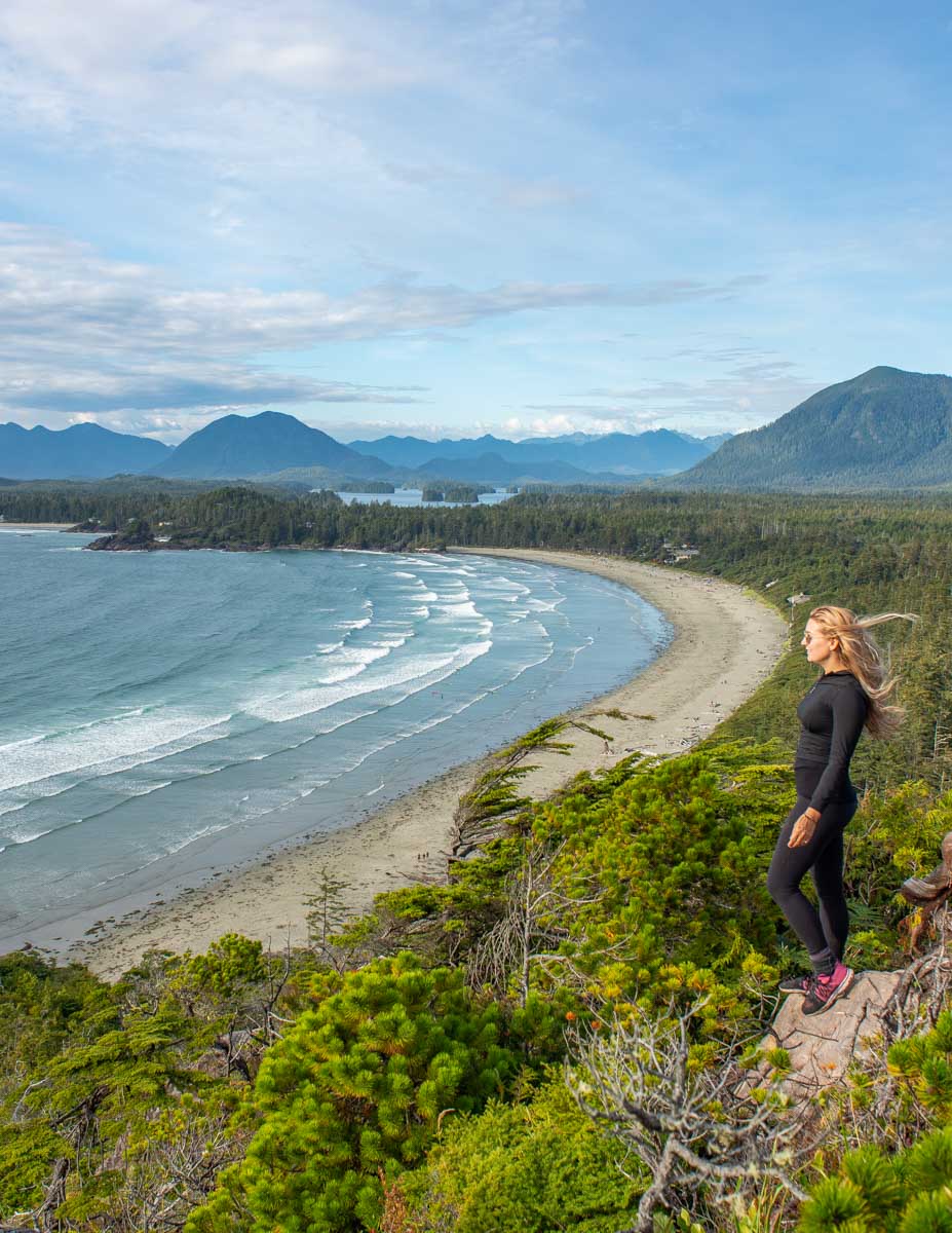 Bailey stands at the top of Cox Bay Lookout at sunset in Tofino