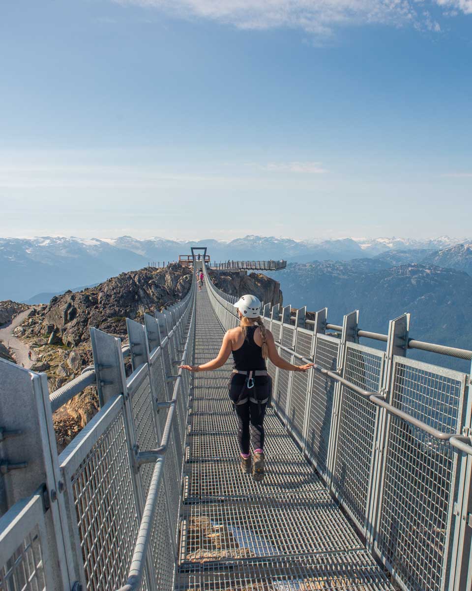 Bailey walks along the Skybridge at the top of the gondola in Whistler, BC