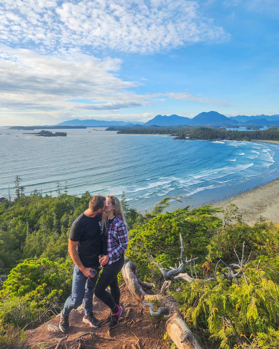 Daniel and Bailey kiss at Cox Bay Lookout in Tofino