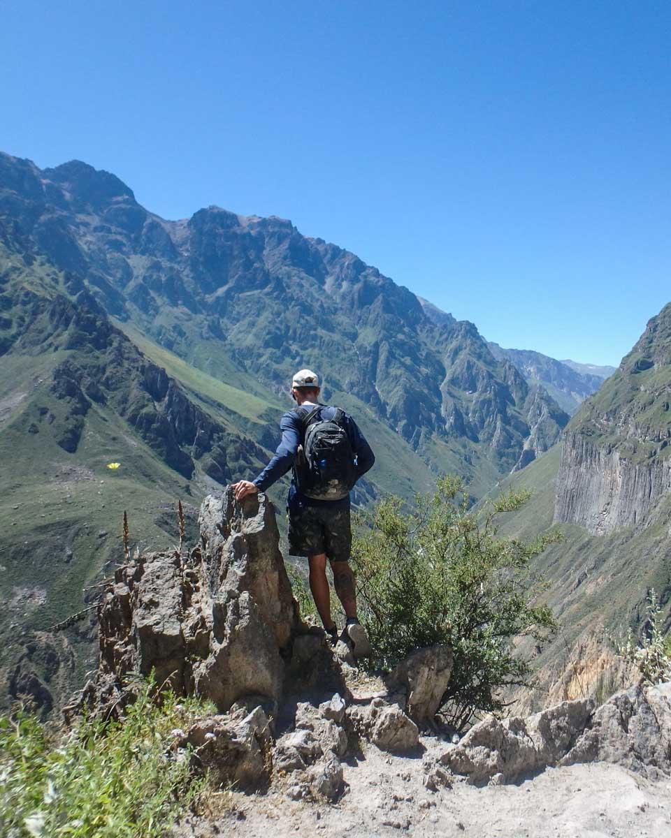 Daniel looks over an edge in the colca Canyon on a tour from Arequipa