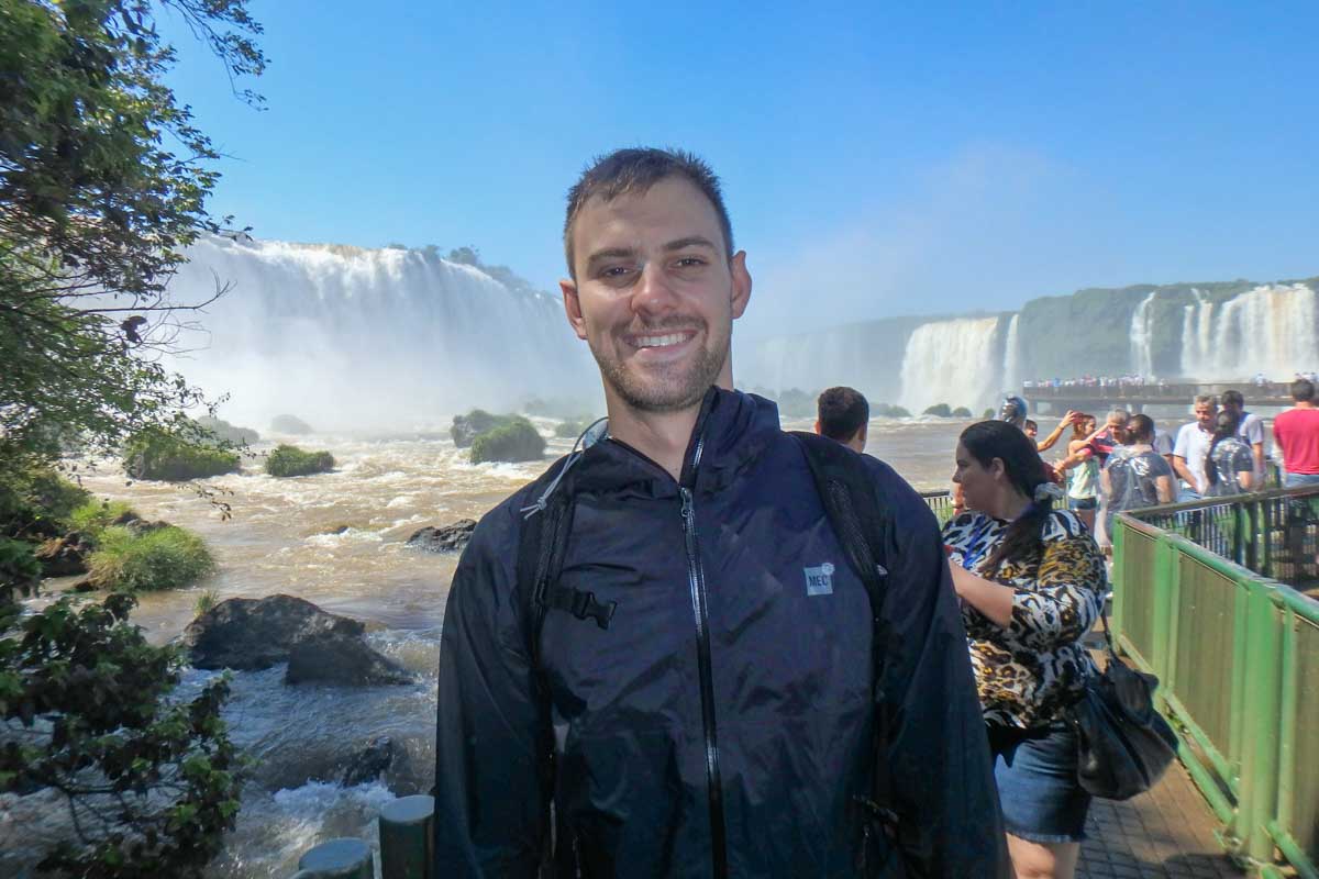 Daniel smiles at the camera at Iguazu Falls