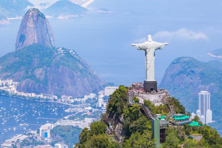 The Christ the Redeemer with Rio de Janeiro in the background as seen from a scenic flight in Rio de Janeiro