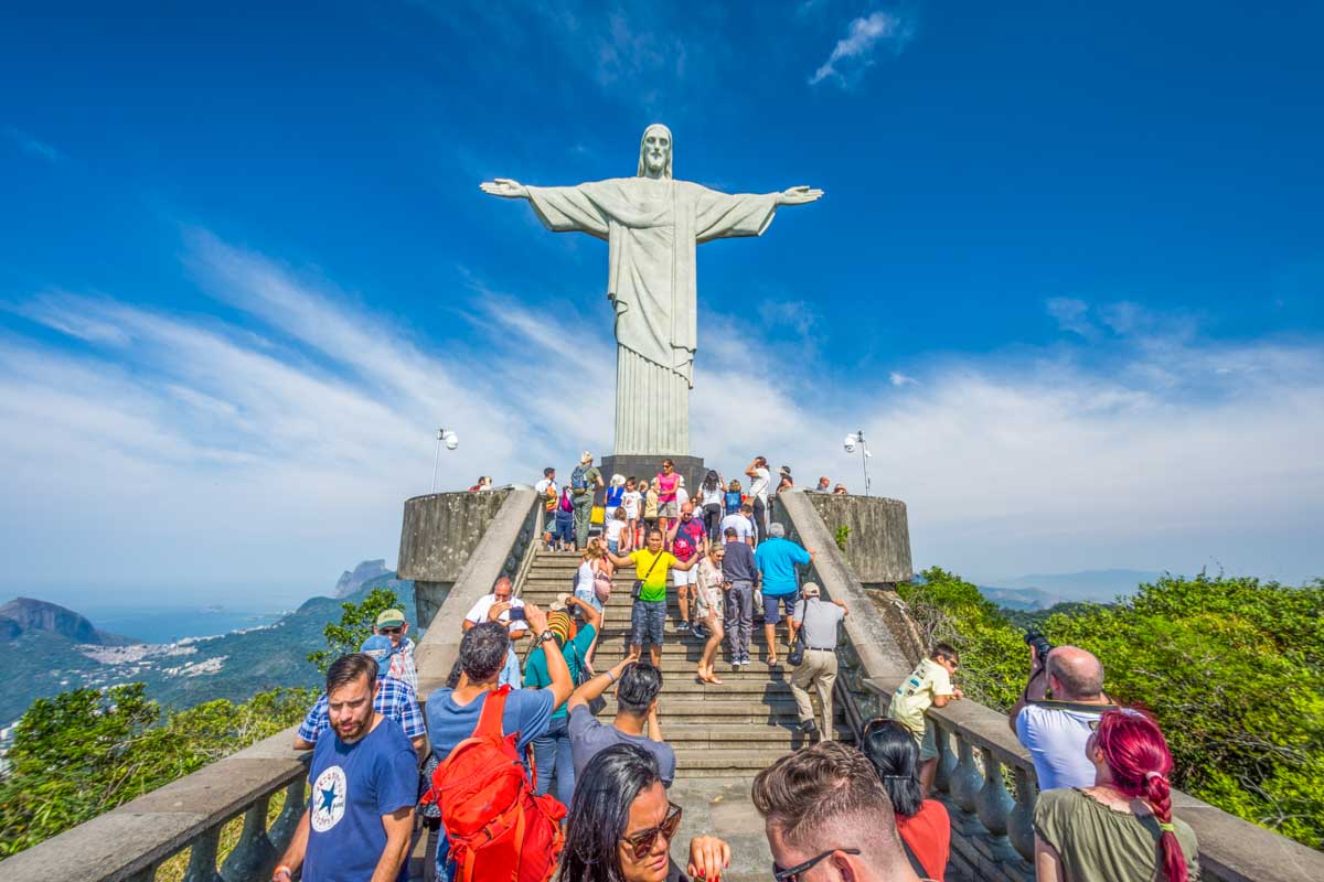 Tourists line up below the Christ the Redeemer Statue in Rio de Janeiro, Brazil