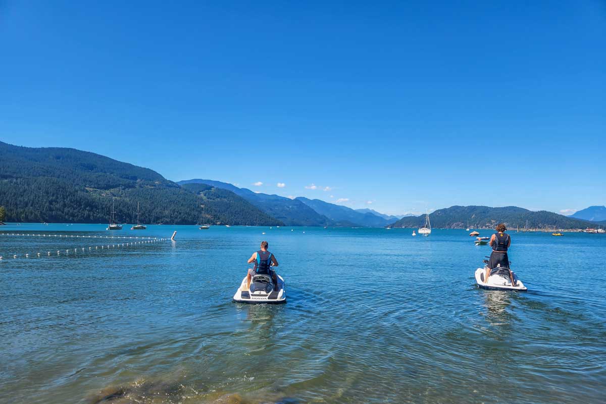 Two people on a jet skis on Harrison Lake in Harrison Hot Springs, Canada