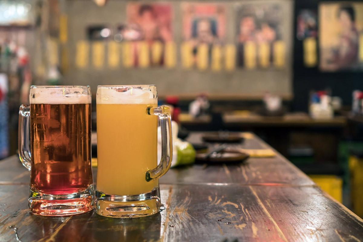 Two Glasses of Beer on the wooden table in bar