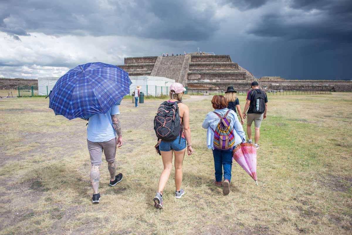 A group of people with a giode explore Teotihuacan, Mexico