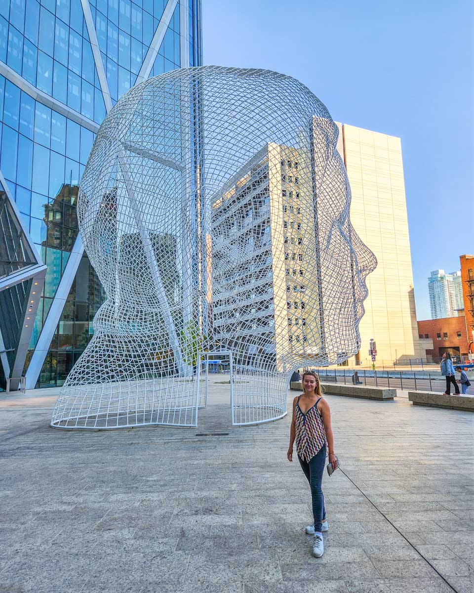 Bailey at the Wonderland Statue in front of the Bow Building