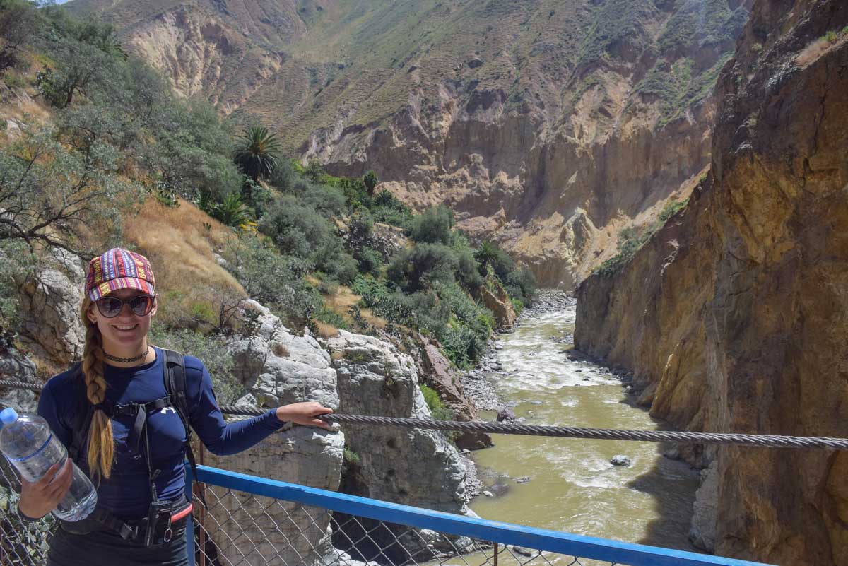 Bailey crosses a suspension bridge in Colca Canyon, Peru