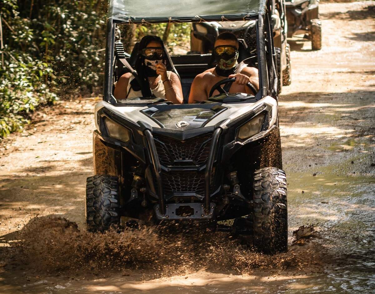 two people riding in a buggy in Playa del Carmen