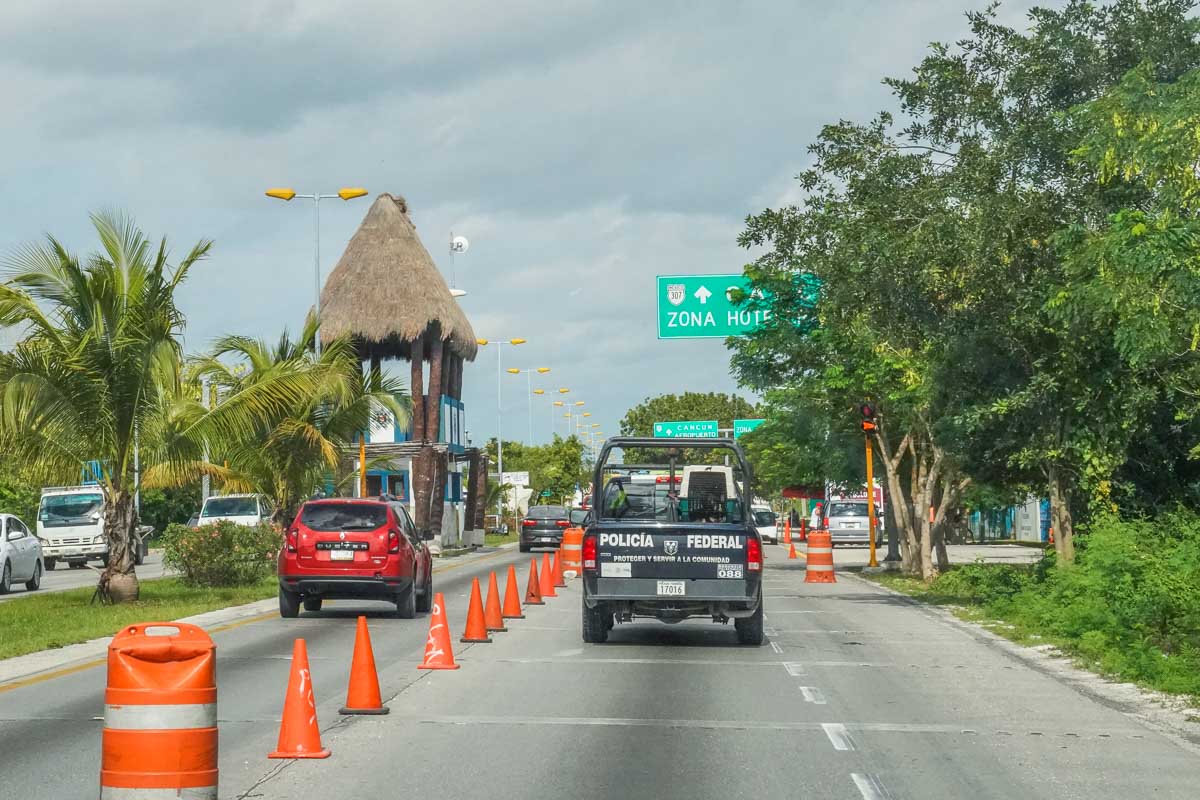Police in Cancun drive into the hotel zone