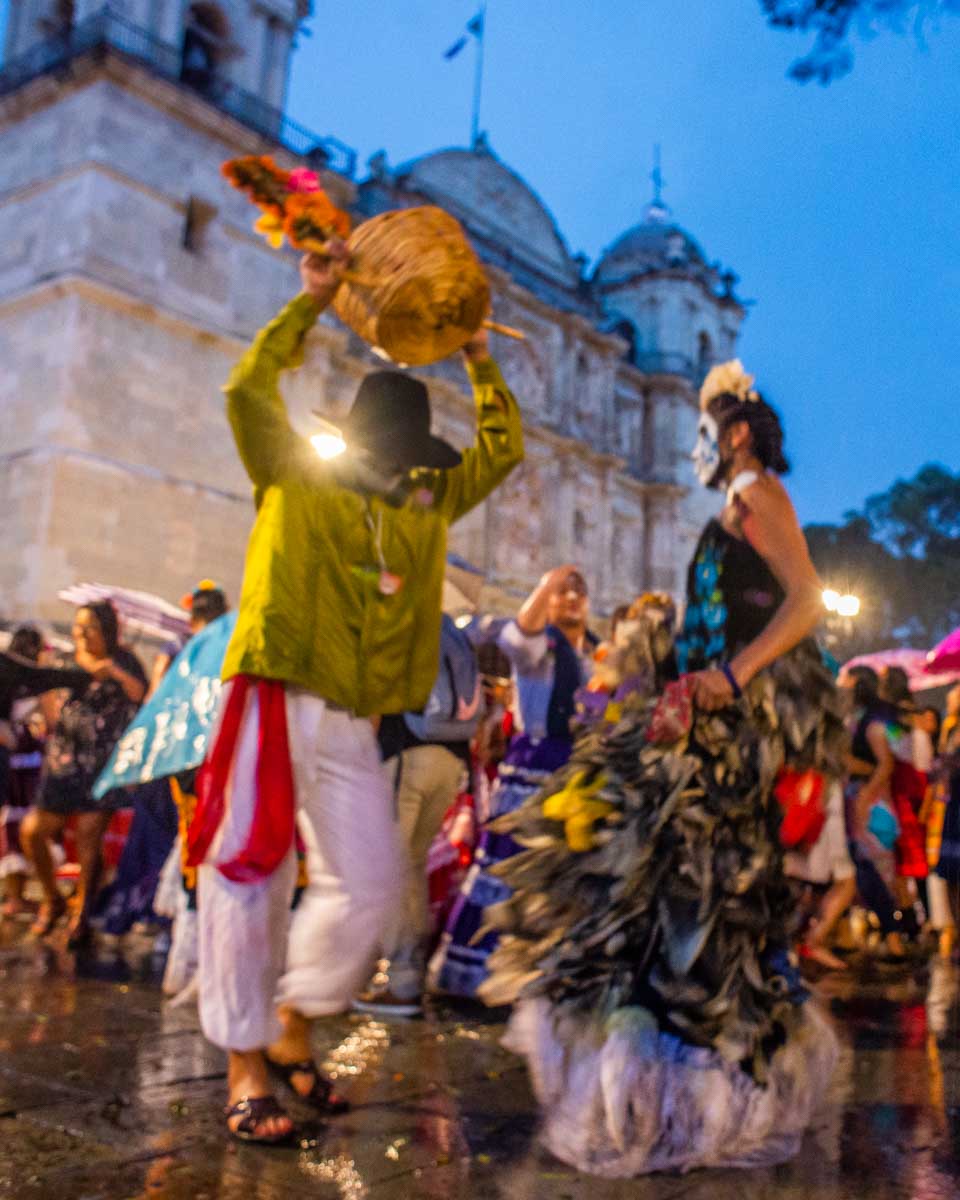 Two people dressed up dance in Oaxaca during Día de los Muertos
