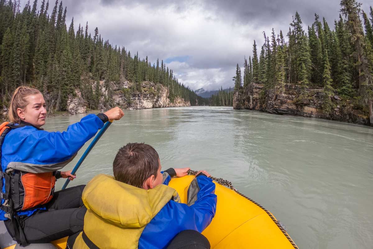 Bailey paddles the raft while white water rafting in Jasper