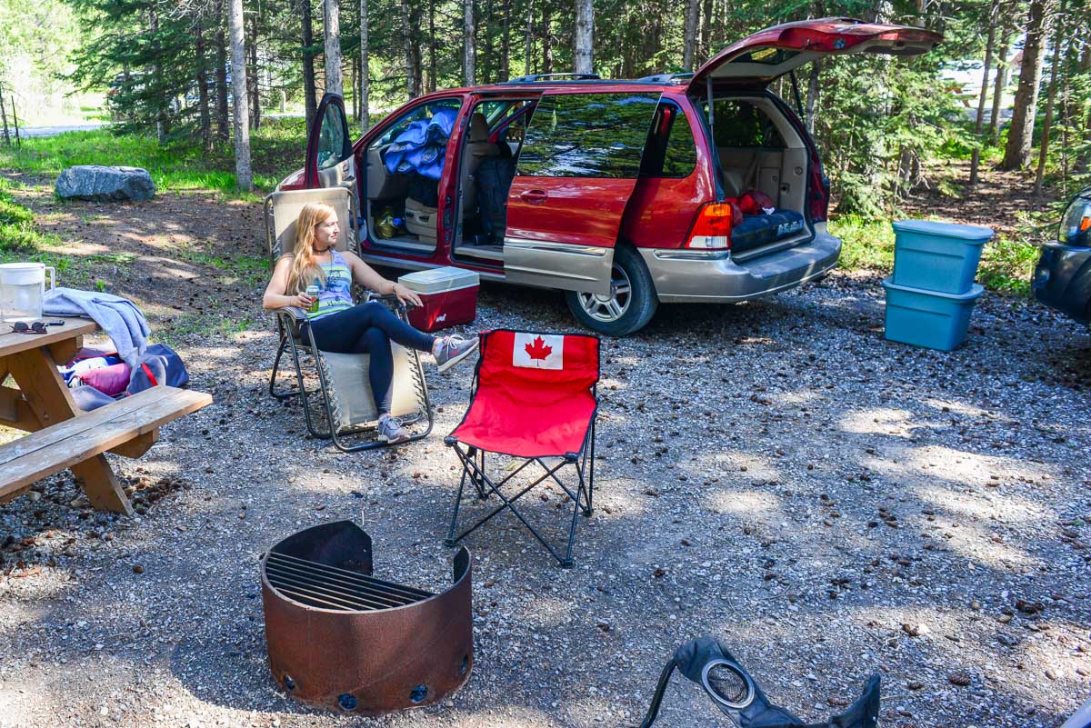 Bailey sits in a camp chair in Bow Valley campground in Bow Valley Provincial Park