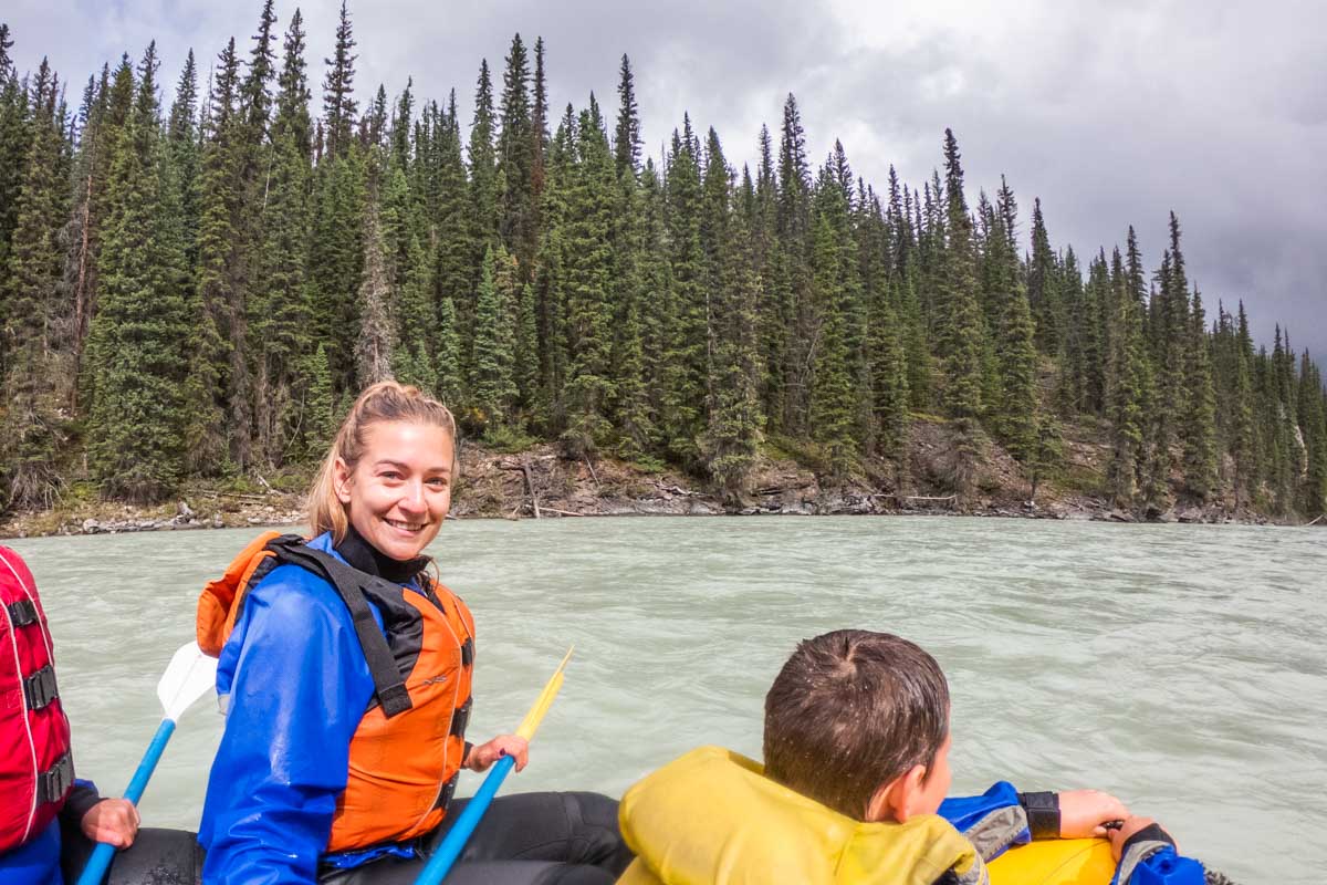 Bailey smiles at the camera while white water rafting in Jasper