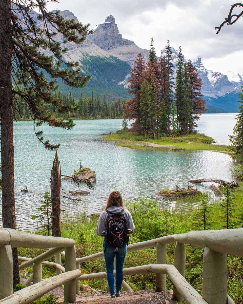 Bailey walks the pathway along the shores of Maligne Lake looking out at Spirit Island