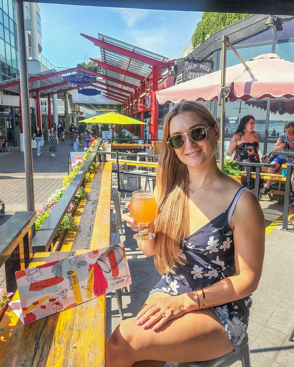 Bailey with a beer from Green Leaf Brewing Company in Lonsdale Quay