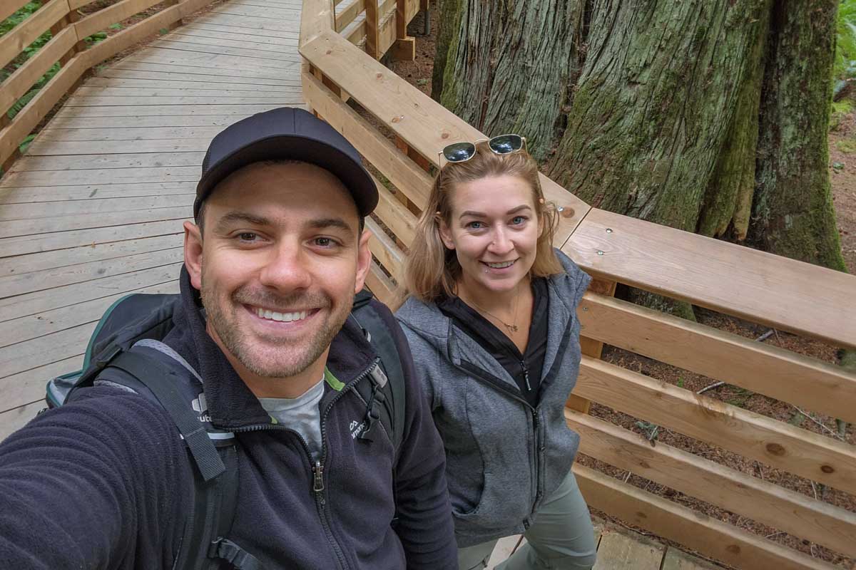 Daniel and Bailey take a selfie while walking Cathedral Grove, Canada