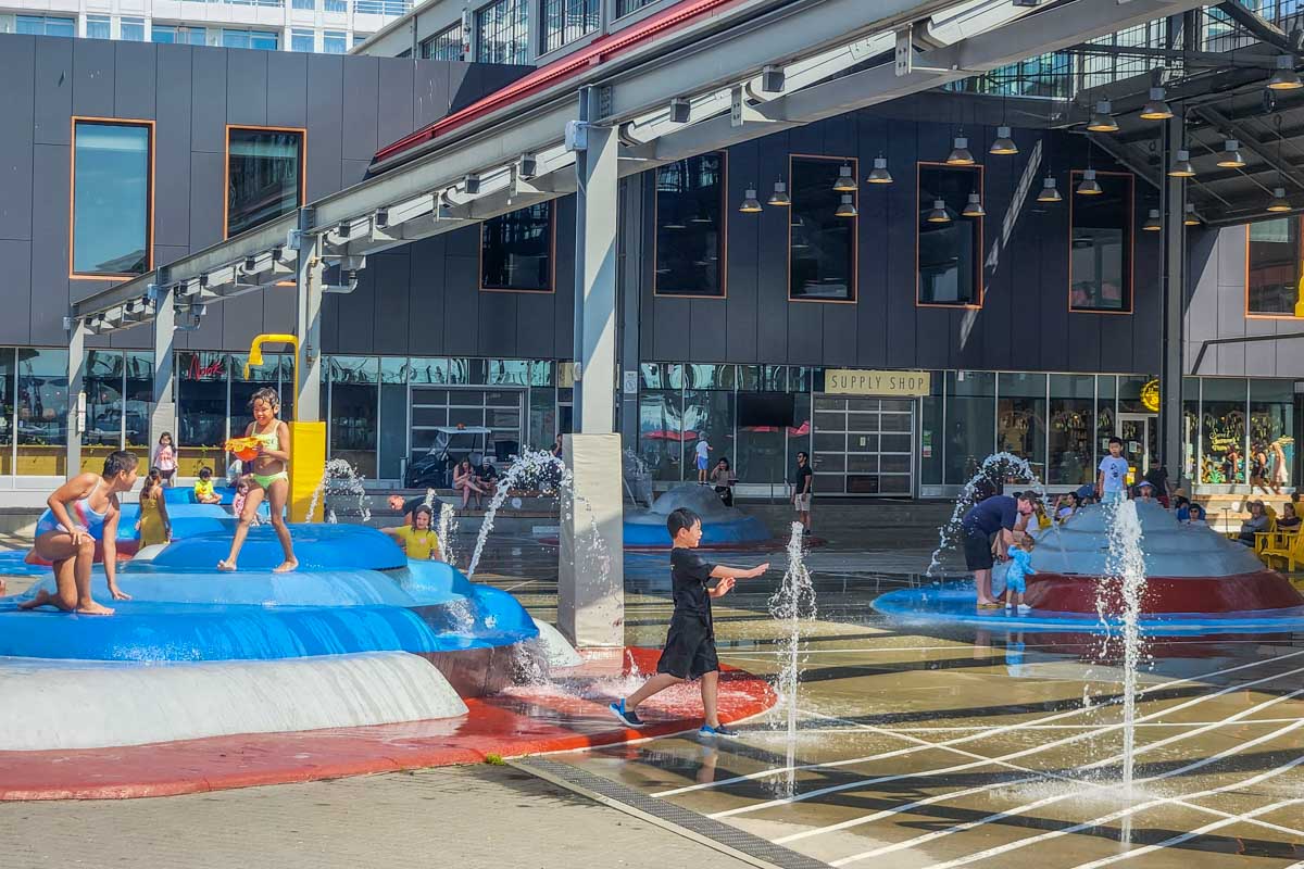 Kids play in The Shipyards Waterpark at Lonsdale Quay
