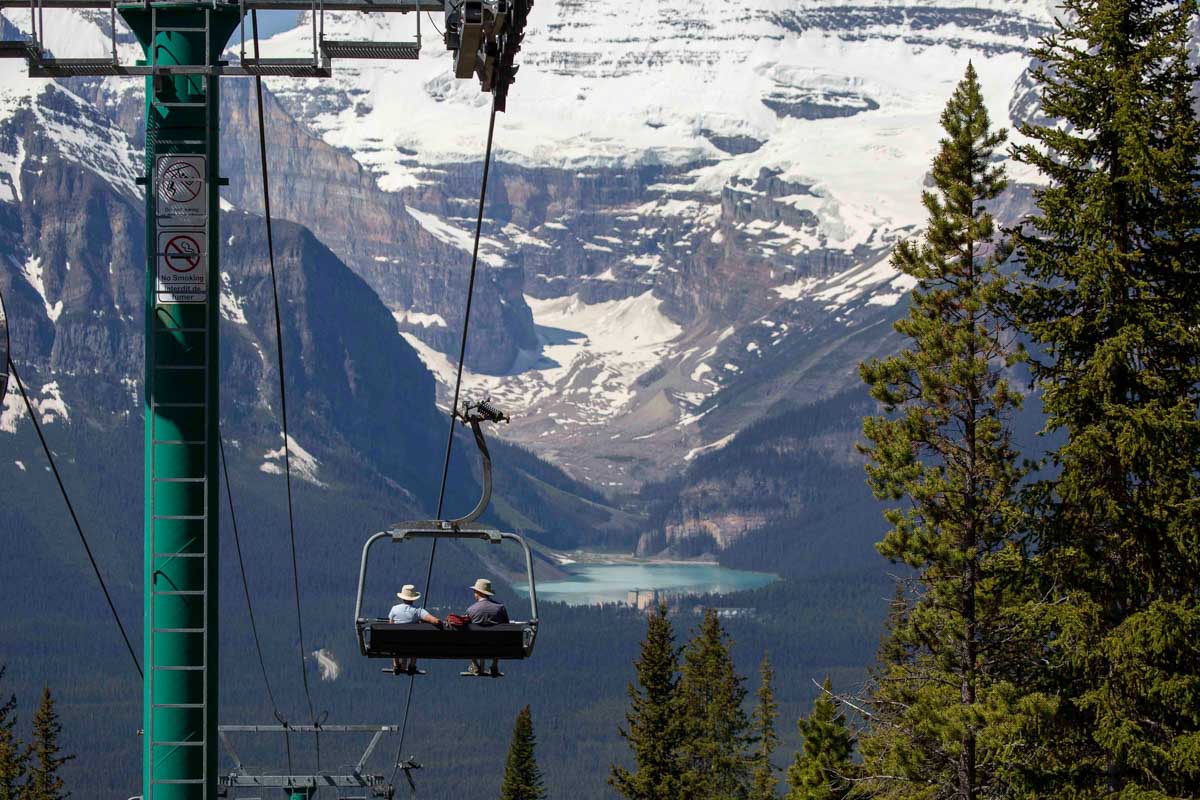 Two people travel down the Lake Louise Sightseeing Gondola