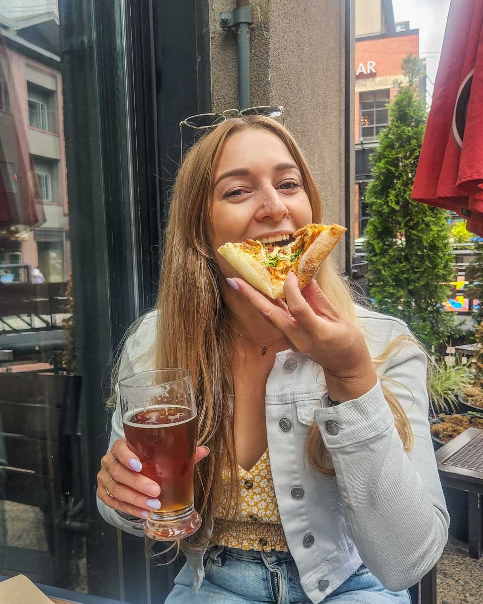 Bailey eats pizza and drinks beer at Yaletown Brewing Co in Yaletown, Vancouver