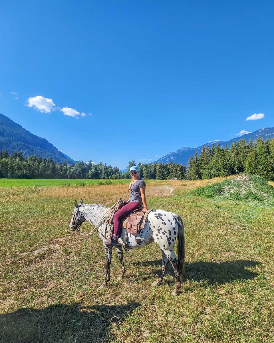 Bailey poses for a photo on her horse on a horseback riding tour in Pemberton BC