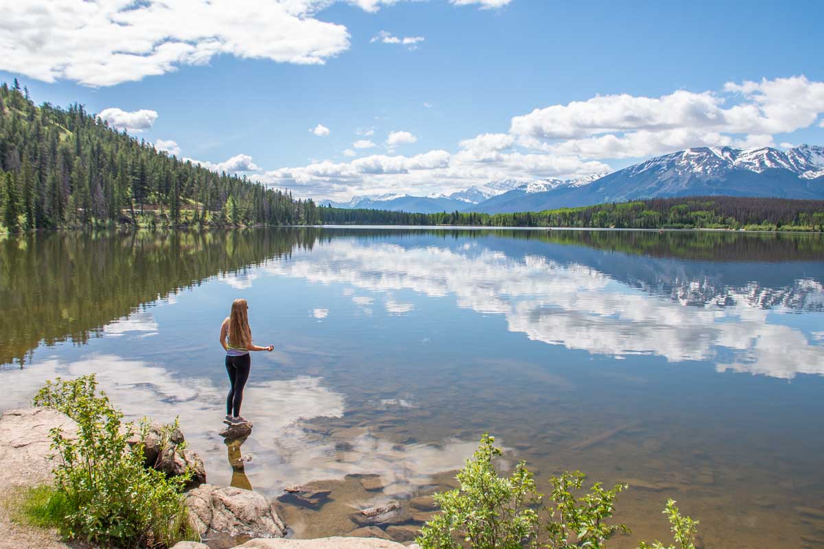 Bailey stands on the edge of Pyramid Lake in Jasper National Park, Canada