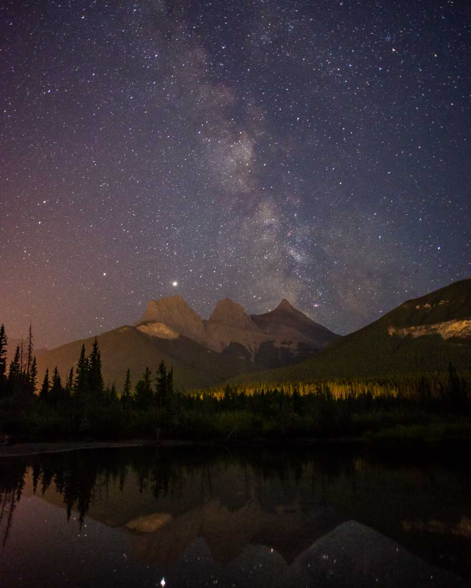 The Three Sisters at night with the Milky Way above on a night tour in Canmore