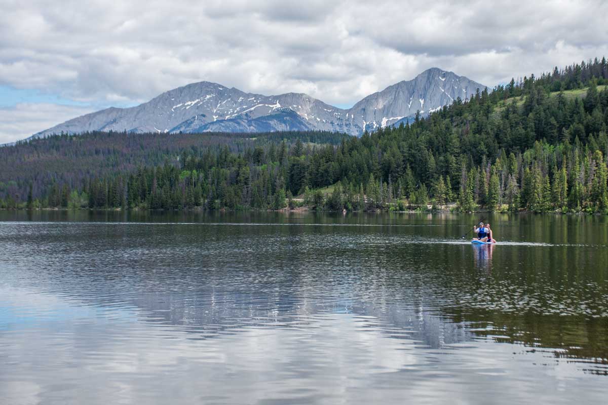 Two people SUP at Pyramid Lake in Jasper National Park, Canada