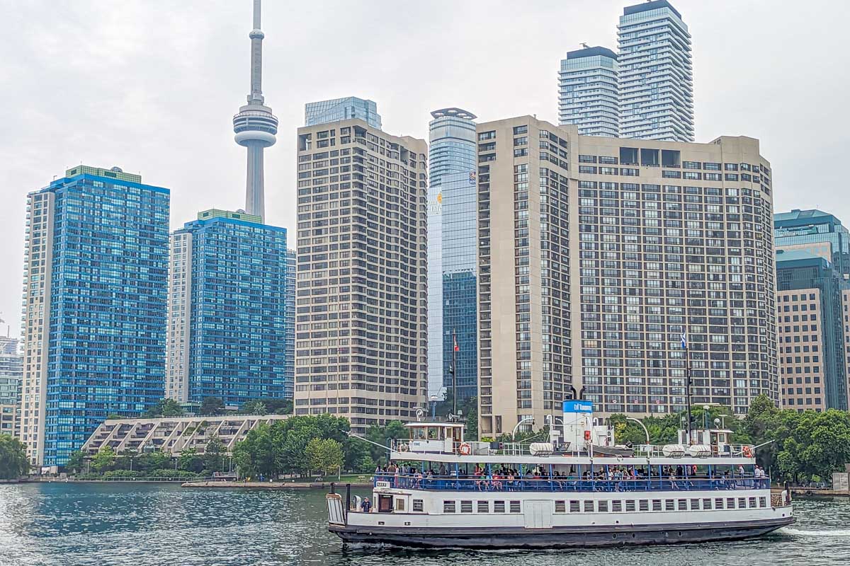 A ferry leaves Toronto and heads to the Toronto Islands to transport guests