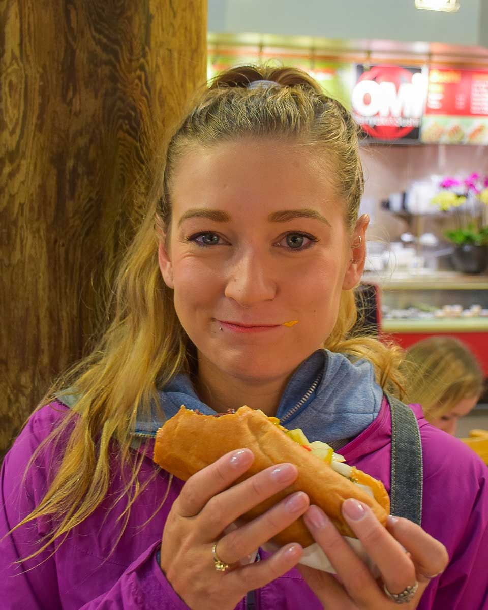 Bailey eats a hotdog at the Granville Island Public Market