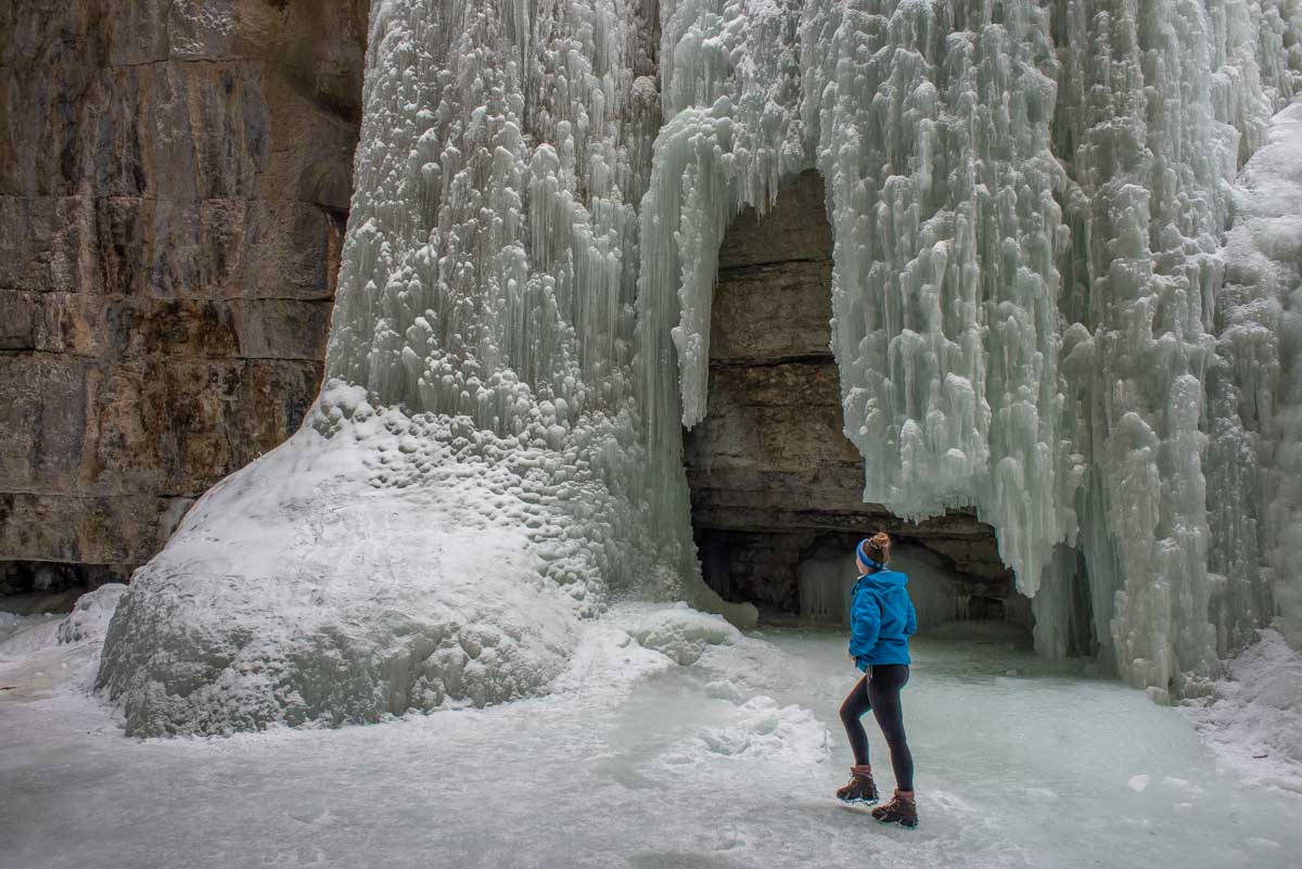 Bailey looks up at a frozen waterfall in Maligne Canyon, Jasper