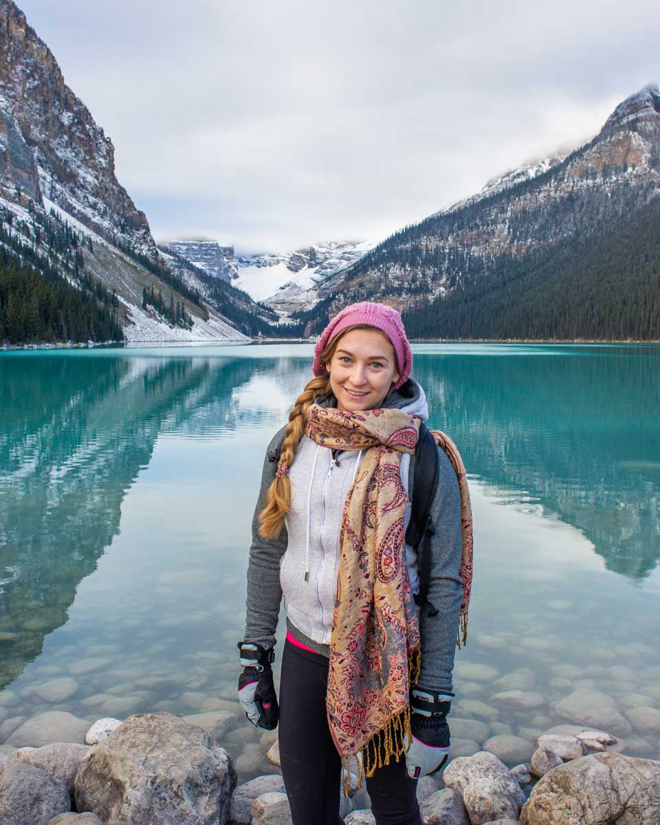 Bailey stands on the shore in Lake Louise during early spring