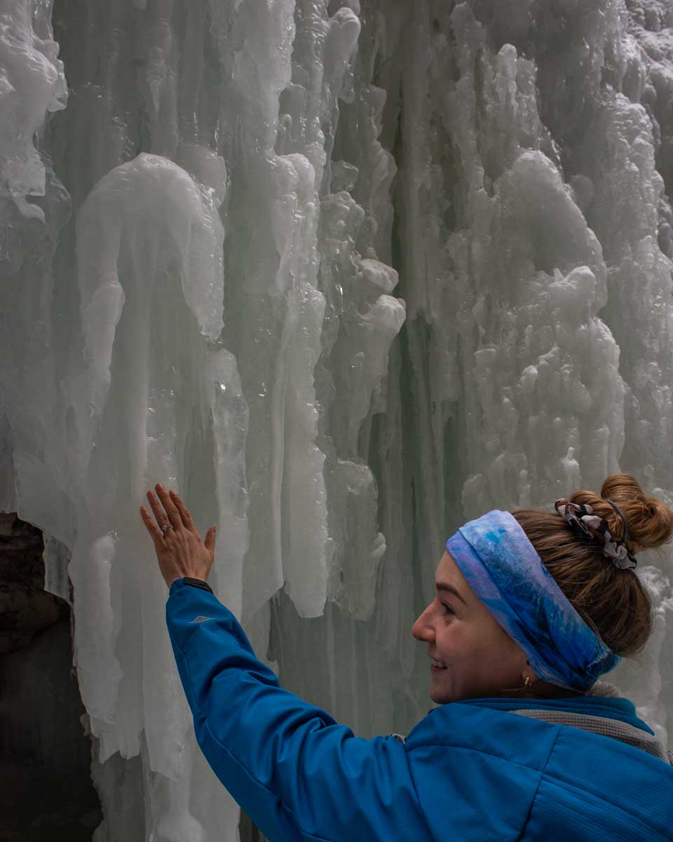 Bailey touches one of the ice waterfalls in Maligne Canyon