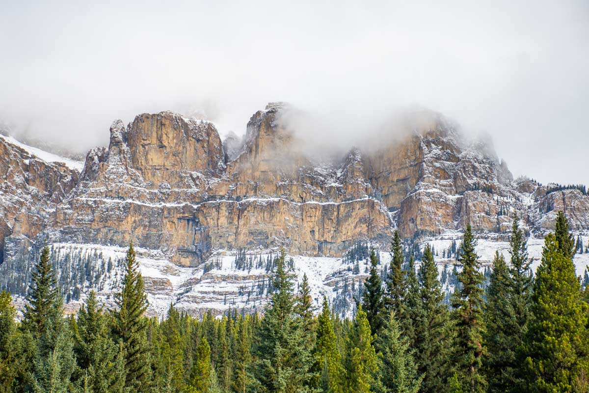 Castle mountain covered in snow and cloud along the Bow Valley Parkway