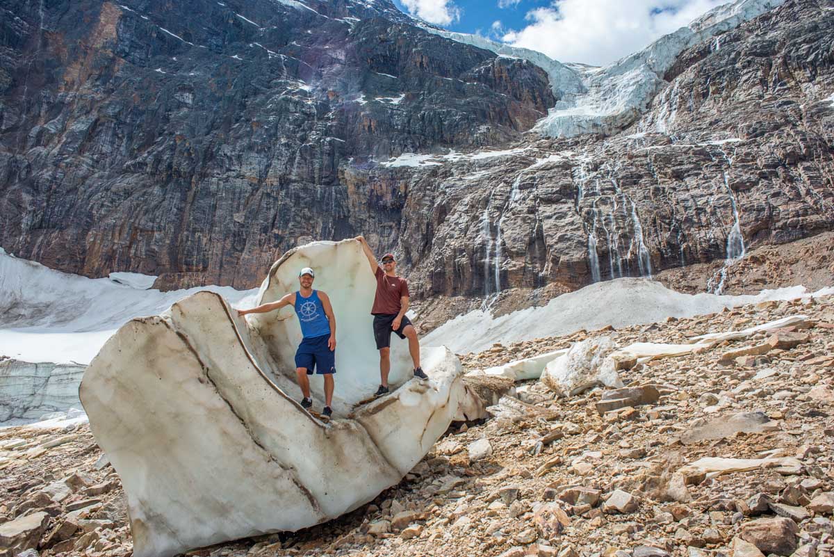 Daniel and a friend stand on a chunk of ice that fell from Edith Cavell glacier at Mount Edith Cavell, Jasper