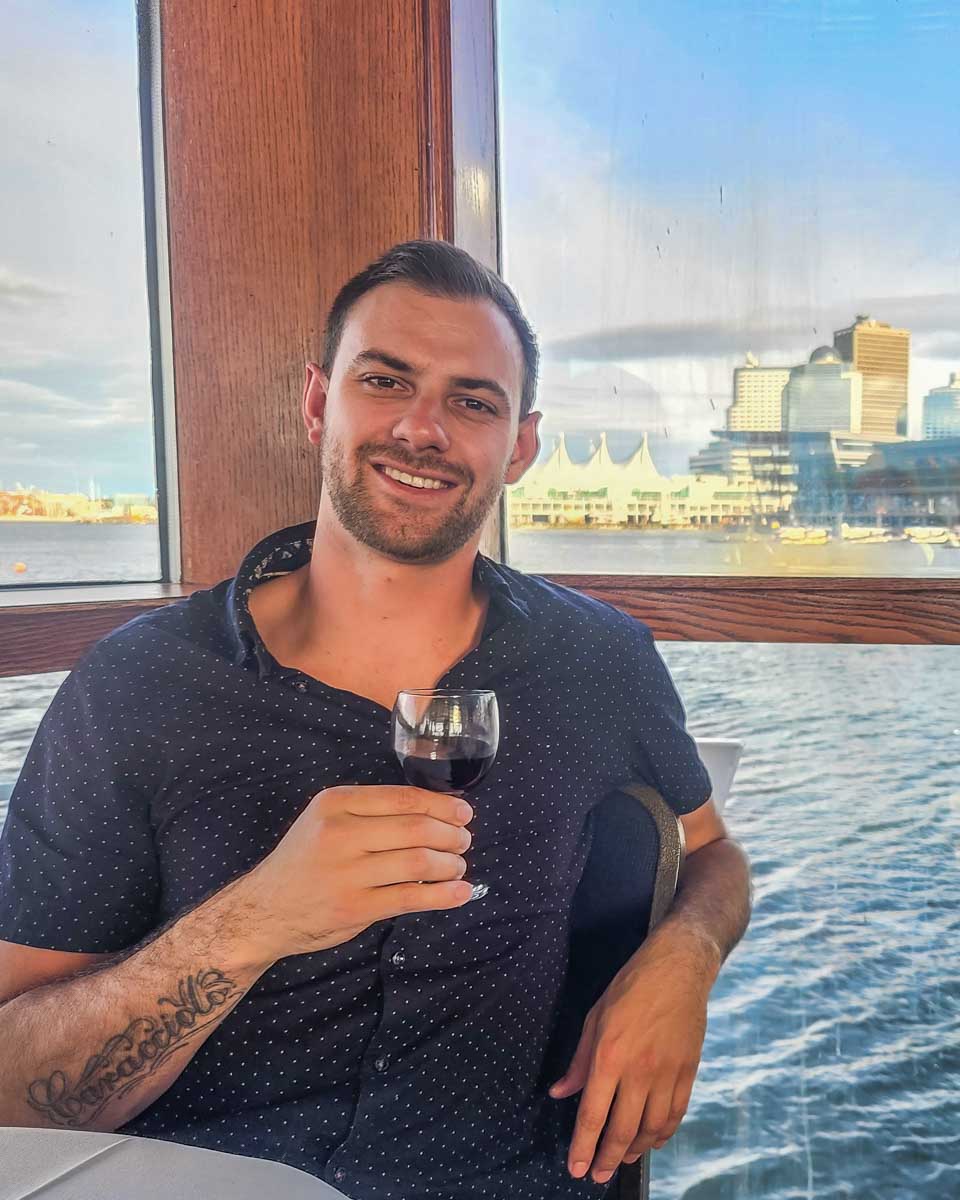 Daniel has a glass of wine on a sunset cruise as we head out in Vancouver, Canada