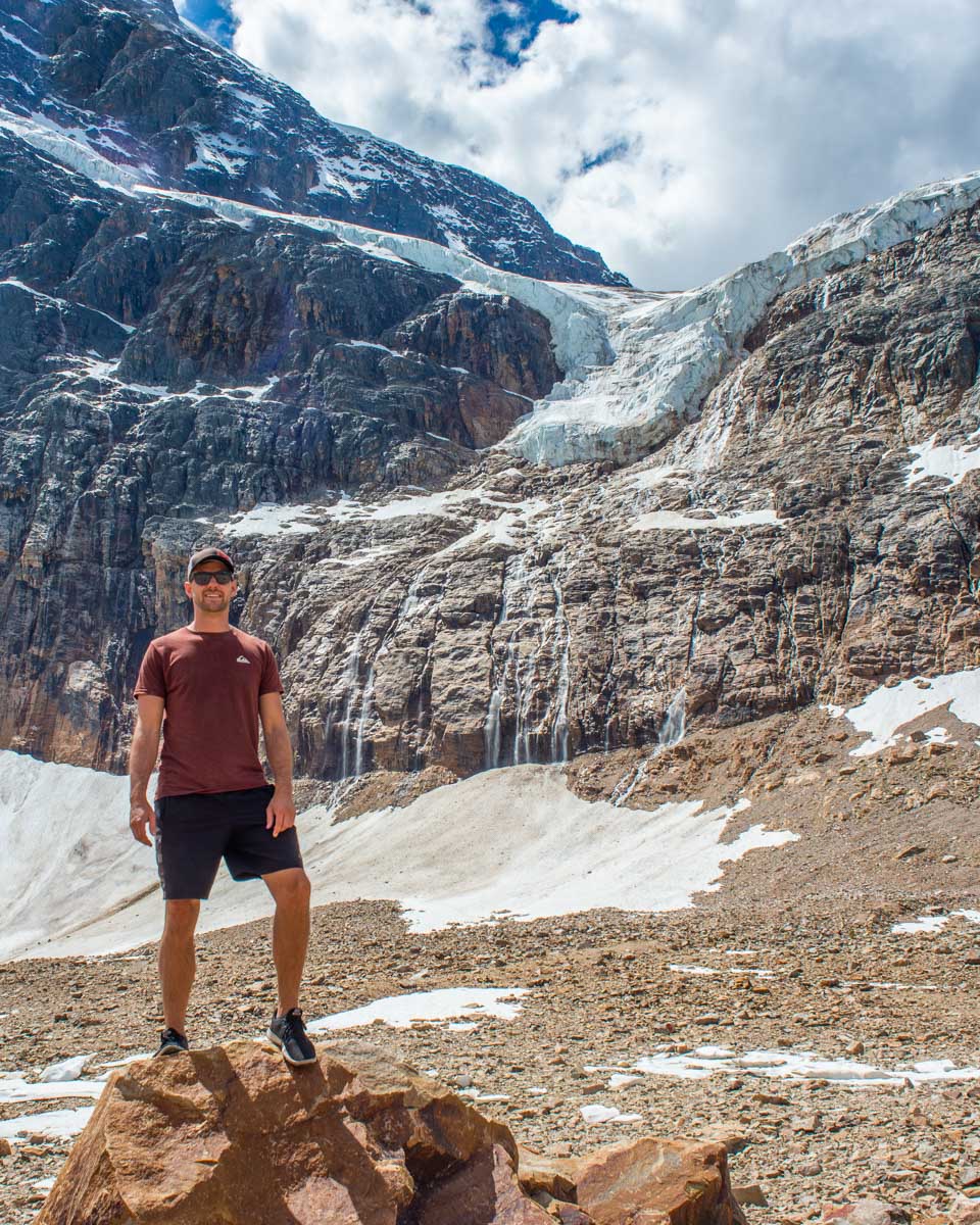 Daniel stands below Edith Cavell Glacier