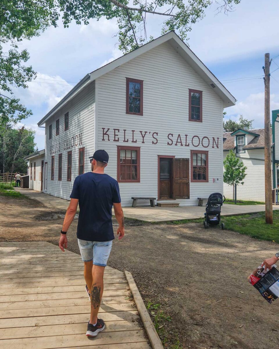 Daniel walks to a saloon in Fort Edmonton Park